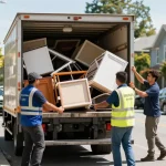 Affordable Junk Removal Vancouver team efficiently loading junk into truck in urban setting.